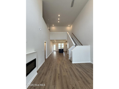 This spacious townhome boasts a first-floor primary suite, and - photo 4