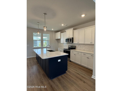 This spacious townhome boasts a first-floor primary suite, and - photo 8