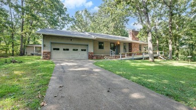 Come home to this charming house nestled in the woods on over an - photo 11