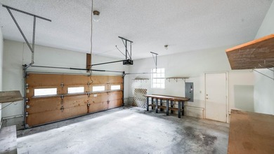 Come home to this charming house nestled in the woods on over an - photo 36