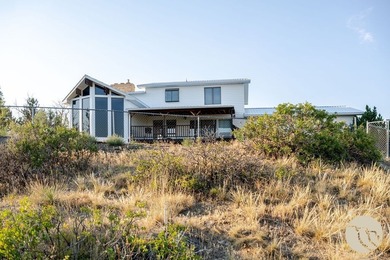Perched above the city on 1.09 acres, 1428 Rawhide Strip is the - photo 1