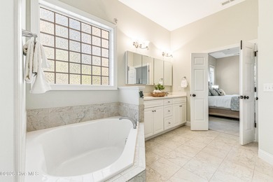 This elegant all-brick, one-level home is perfectly situated in