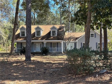 This comfortable cape/colonial home sits on a beautiful wooded - photo 1