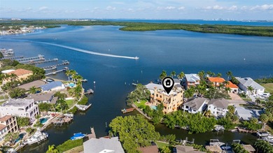 Commanding a premier position at the point of Bayou Grande, this