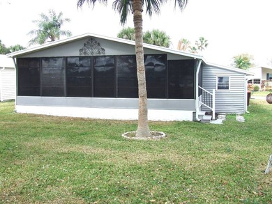 LARGE GREEN SPACE FACING THE WATER FROM A LARGE FLORIDA ROOM - photo 7