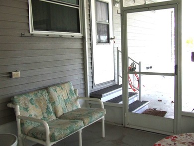 LARGE GREEN SPACE FACING THE WATER FROM A LARGE FLORIDA ROOM - photo 8
