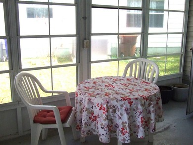 LARGE GREEN SPACE FACING THE WATER FROM A LARGE FLORIDA ROOM - photo 9