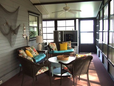 LARGE GREEN SPACE FACING THE WATER FROM A LARGE FLORIDA ROOM - photo 10