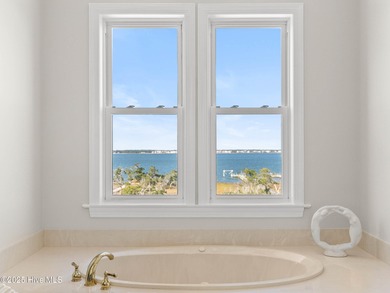 Welcome to this exquisite custom-built soundfront home in