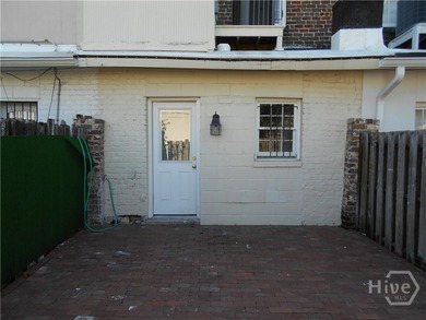 The 2-story brick townhome is located in a residential - photo 8
