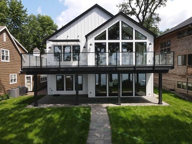 Welcome to an extraordinary lakeside retreat on the coveted - photo 1