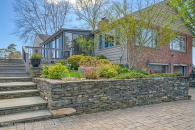 Perched on a commanding 4.5-acre hilltop, this magnificent brick