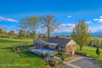 Perched on a commanding 4.5-acre hilltop, this magnificent brick