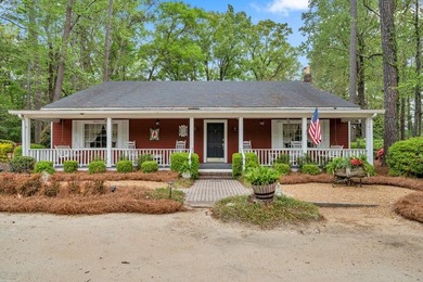 Tucked beneath a canopy of towering trees and vibrant azaleas - photo 1