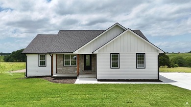 Set on two scenic acres with tranquil pond views, this - photo 1