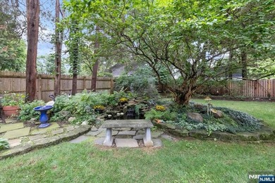 This home is gracefully positioned on a beautifully landscaped - photo 39