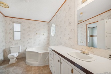 Set on over 1.3 acres in Lakehills, Texas, this 4-bedroom - photo 15