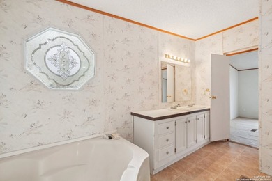 Set on over 1.3 acres in Lakehills, Texas, this 4-bedroom - photo 16