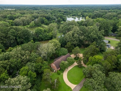 Set on 4.04 acres with pond frontage, this custom-built - photo 3