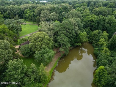 Set on 4.04 acres with pond frontage, this custom-built - photo 4