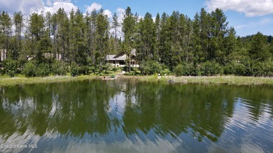 Nestled among mature trees in a private waterside setting, this - photo 2
