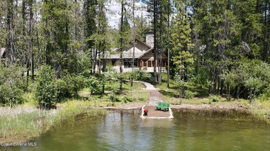 Nestled among mature trees in a private waterside setting, this - photo 3