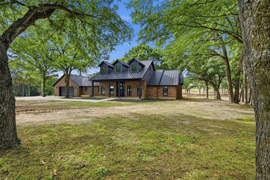 Set on 11 gently rolling acres in Sadler, TX, this beautifully - photo 1