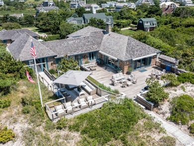 Set along the coveted shores of Dune Road in Quogue, this - photo 29
