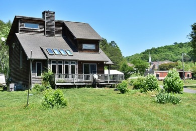 Unlock the potential of this charming lakefront fixer-upper on - photo 1