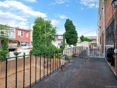 This three-story brick two-family home in Cypress Hills features - photo 12