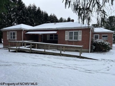 Single, brick ranch style home in a country setting with three