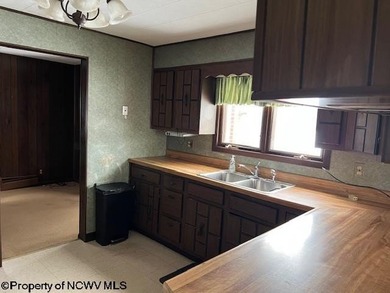 Single, brick ranch style home in a country setting with three