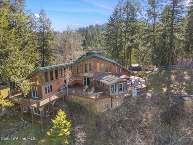 Set on 9.81 private acres with rare dual lake views of Fernan - photo 4