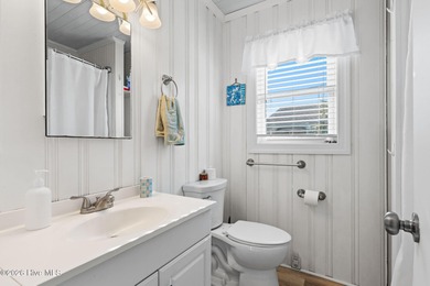 Tucked along a quiet street, this charming coastal cottage