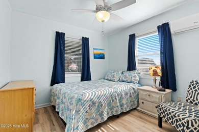 Tucked along a quiet street, this charming coastal cottage