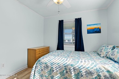 Tucked along a quiet street, this charming coastal cottage