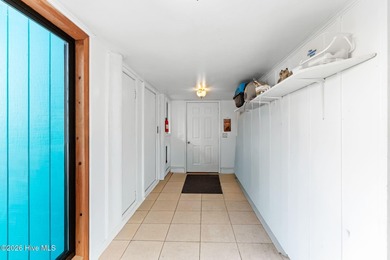 Tucked along a quiet street, this charming coastal cottage