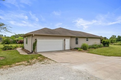 Set back on 5.38 waterfront acres in Mahomet, this custom-built - photo 3