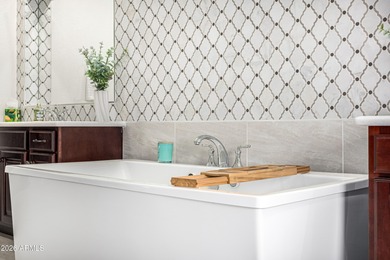 Set on a 1-acre site, this custom estate in the Boulder Ranch