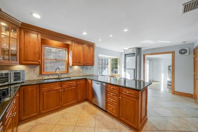 Set within the serene landscape of Rolling Woods in Riverhead - photo 14