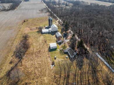 A homestead with 6 acres, several buildings that are set up for