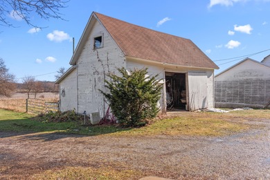 A homestead with 6 acres, several buildings that are set up for