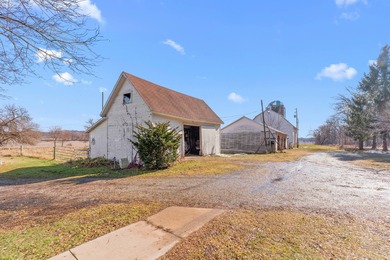 A homestead with 6 acres, several buildings that are set up for