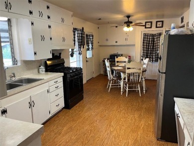 The two-bedroom, one bath home is located on a quiet mature tree