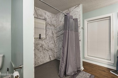 Acadian Style solid metal frame home with metal roof situated on