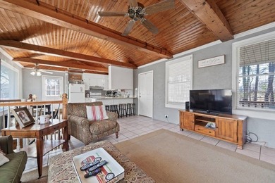 Tucked along the water's edge, this charming rustic cottage is - photo 12