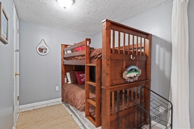 Tucked along the water's edge, this charming rustic cottage is - photo 25