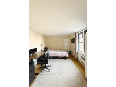 This sun-filled residence features a private balcony and windows - photo 8