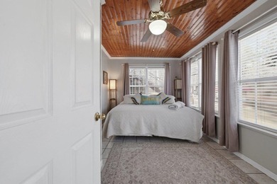 Tucked along the water's edge, this charming rustic cottage is - photo 32