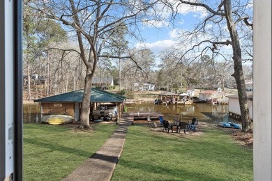 Tucked along the water's edge, this charming rustic cottage is - photo 35